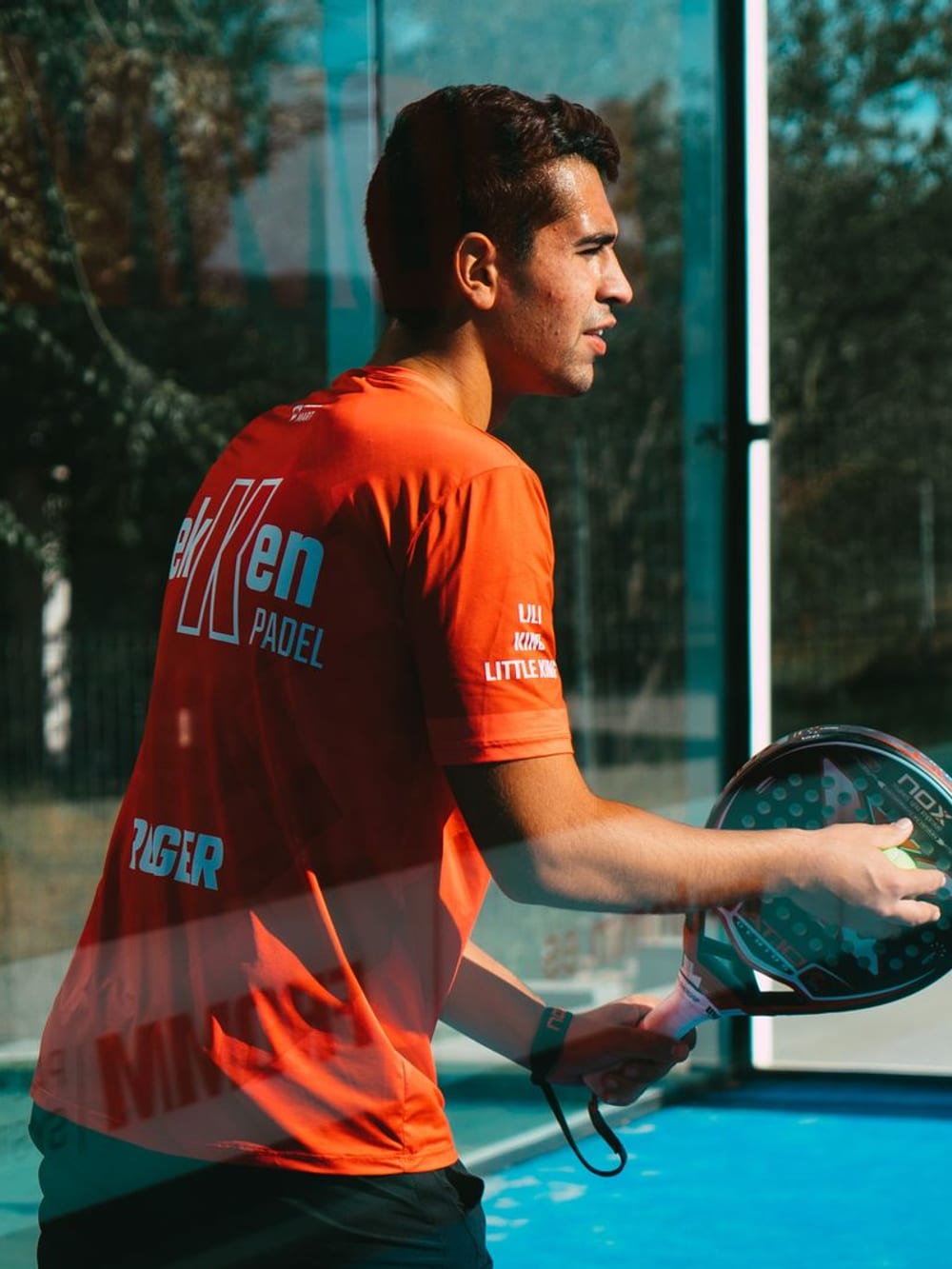 A player reaching for a shot on court – Padel