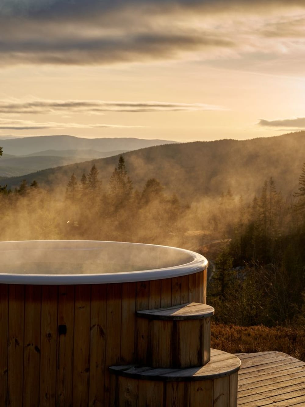 A wood-fired hot tub steaming at dusk – Outdoor wellness