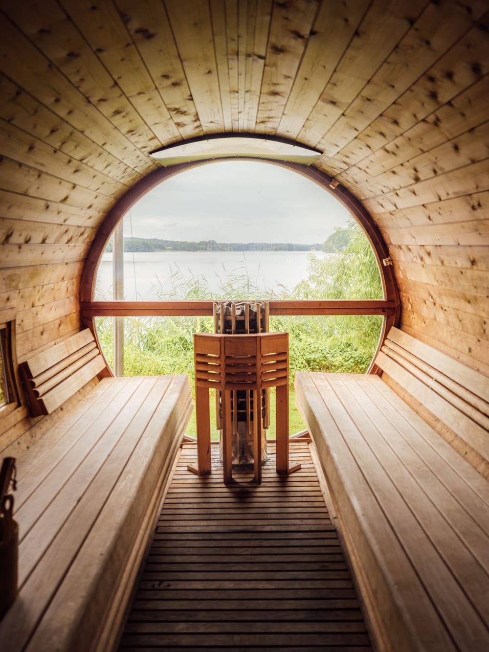A barrel sauna looking out over water – Outdoor wellness