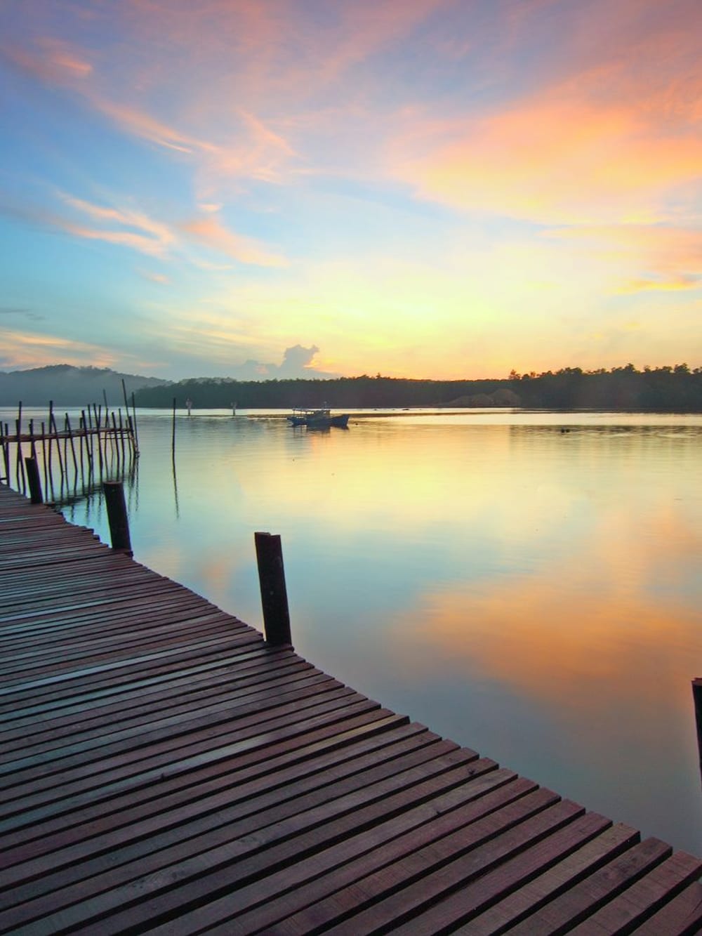 A wooden jetty reaching into a lake at sunset – Lakeside