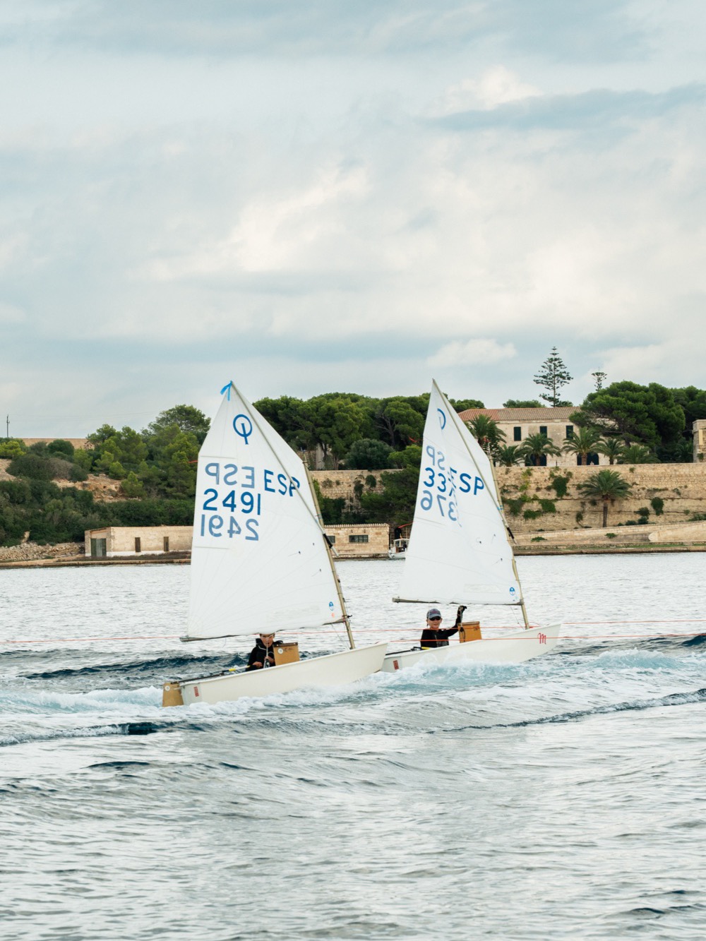 Two small sailing boats crossing the bay – Menorca coast